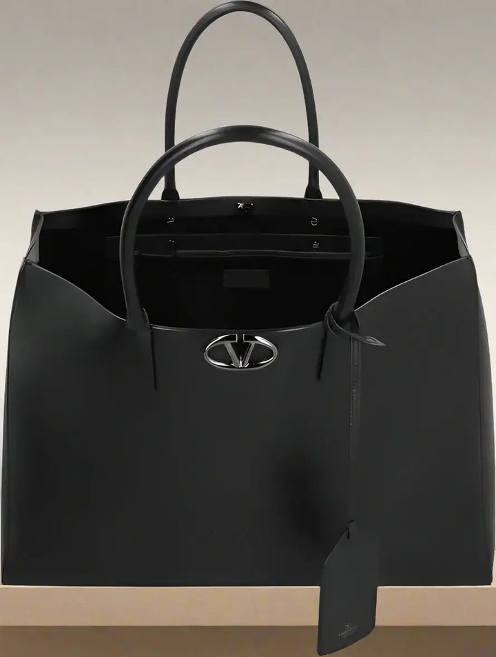 Black handbag with a visible brand logo on a white background