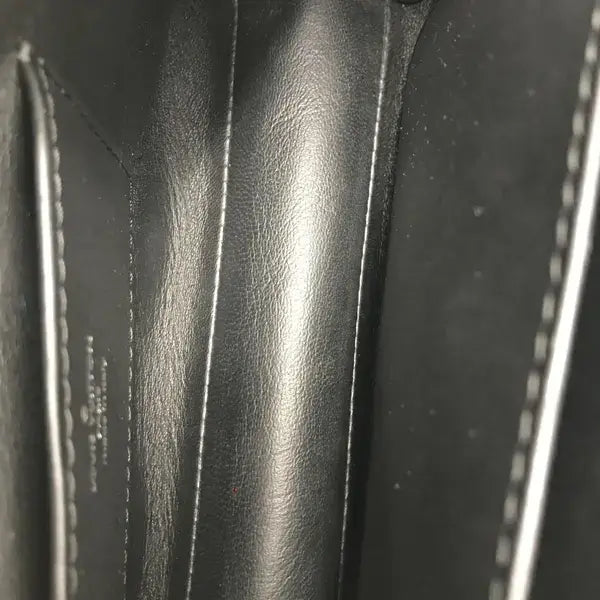 Close-up of black leather with visible stitching