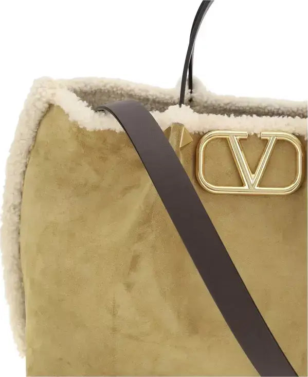 Beige handbag with a gold logo on a white background