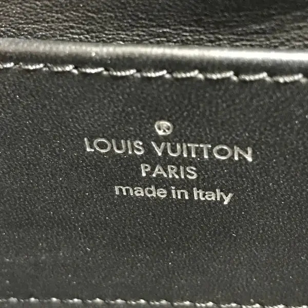 Louis Vuitton logo on a black leather surface