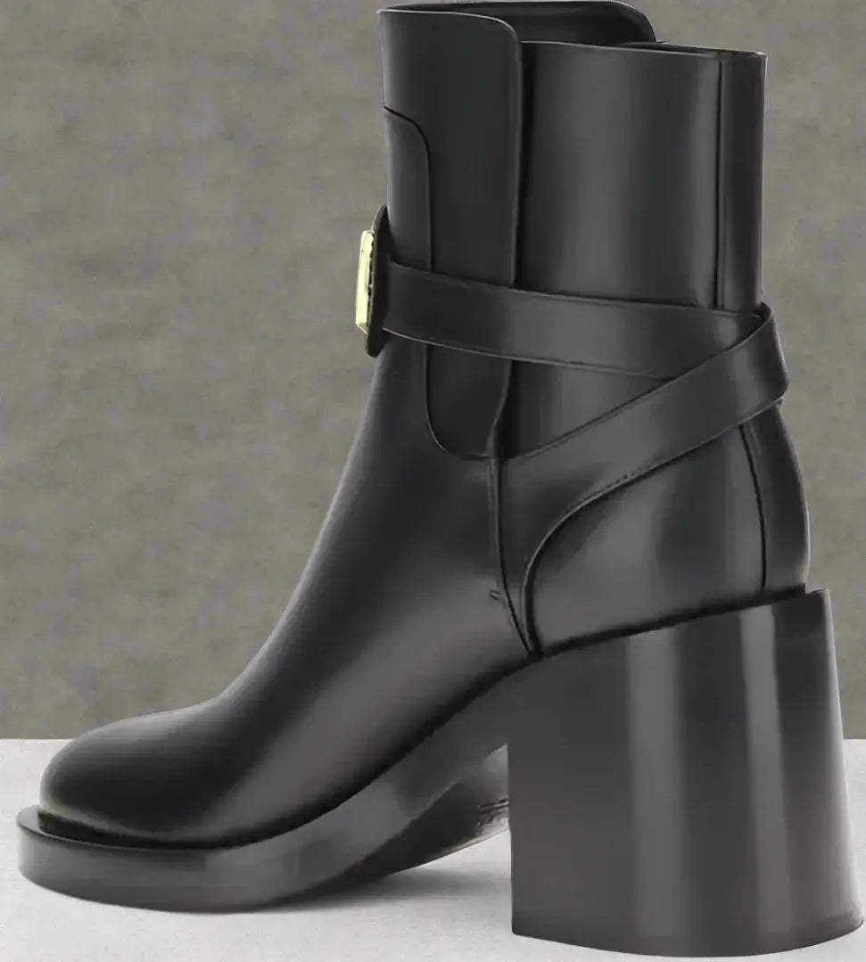 Black ankle boot with block heel on a white background