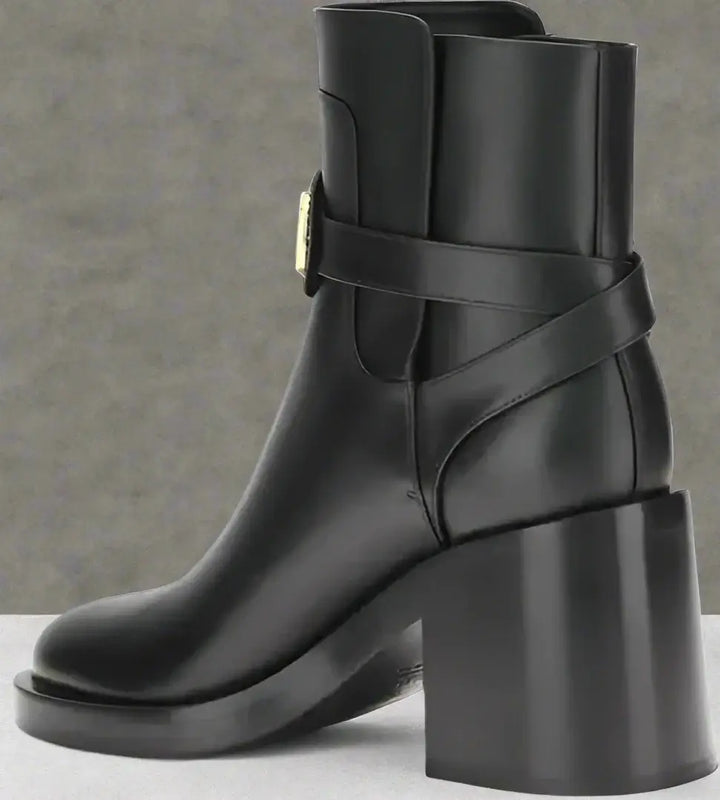 Black ankle boot with block heel on a white background