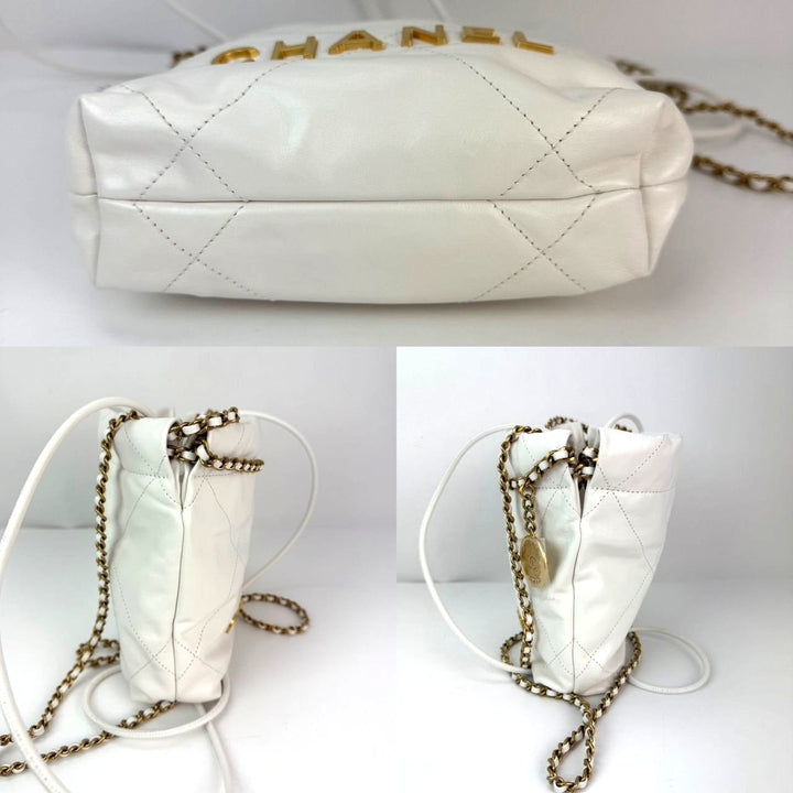 White quilted handbag with gold chain strap on a white background