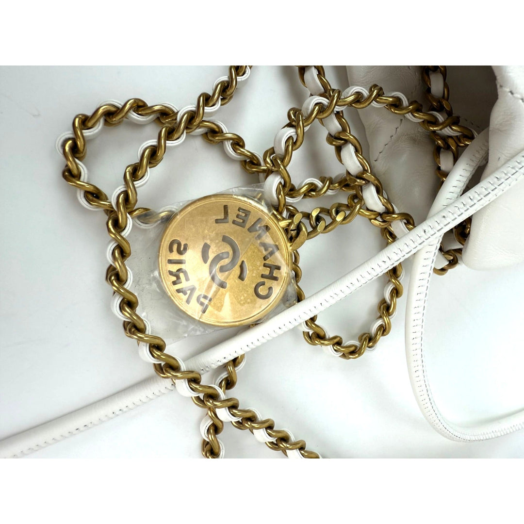 Gold chain belt with a round gold buckle on a white background