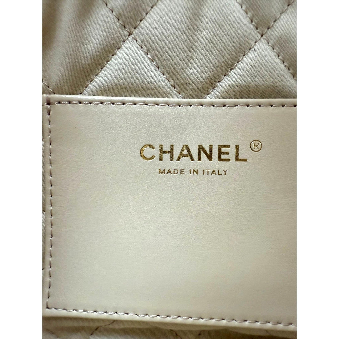 Close-up of a Chanel wallet with quilted design and brand logo.