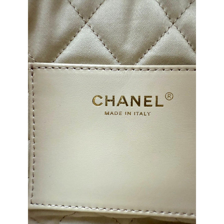 Close-up of a Chanel wallet with quilted design and brand logo.