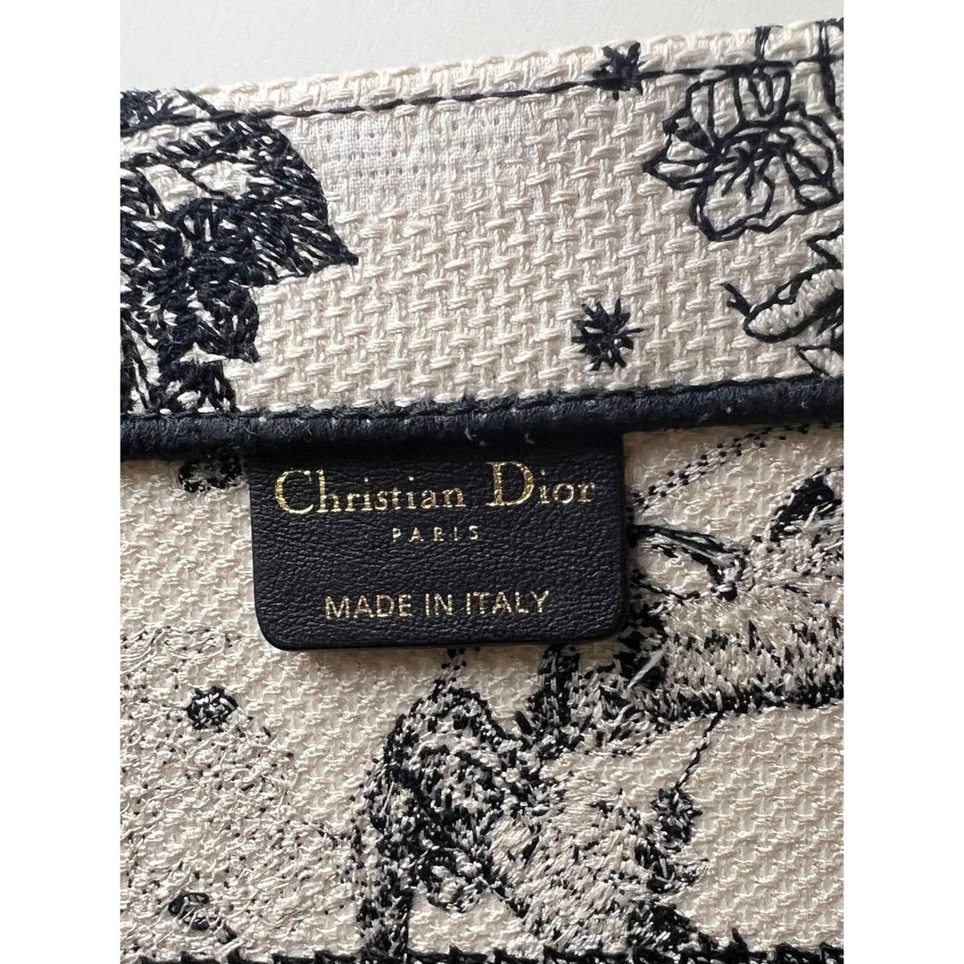 Christian Dior Book Embroidered Canvas Medium Stars and Signs Black Tote label showcasing luxury craftsmanship and authentic branding.