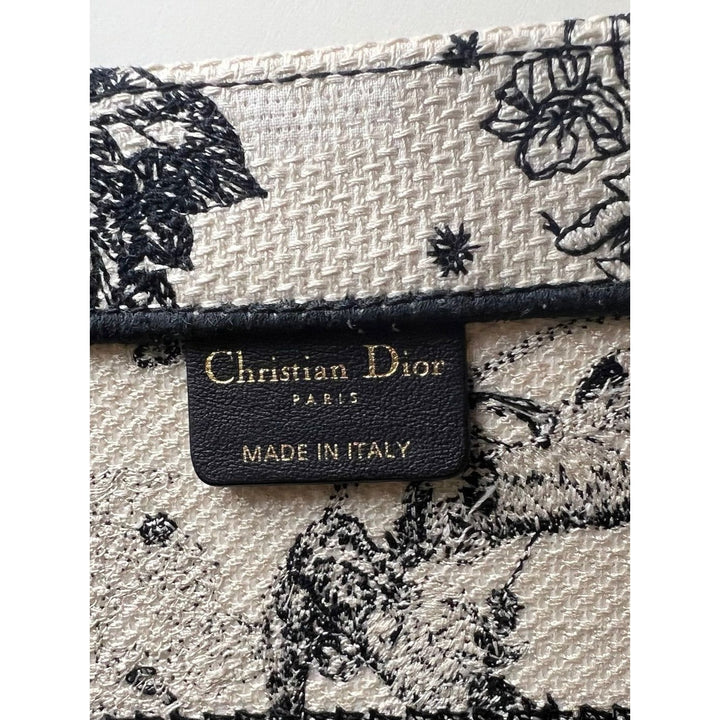 Christian Dior Book Embroidered Canvas Medium Stars and Signs Black Tote label showcasing luxury craftsmanship and authentic branding.