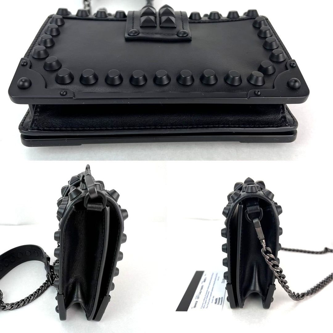 Black studded handbag with chain detail on a white background