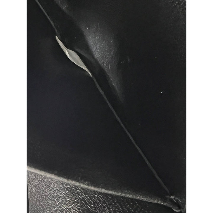 Close-up of black leather surface with visible texture