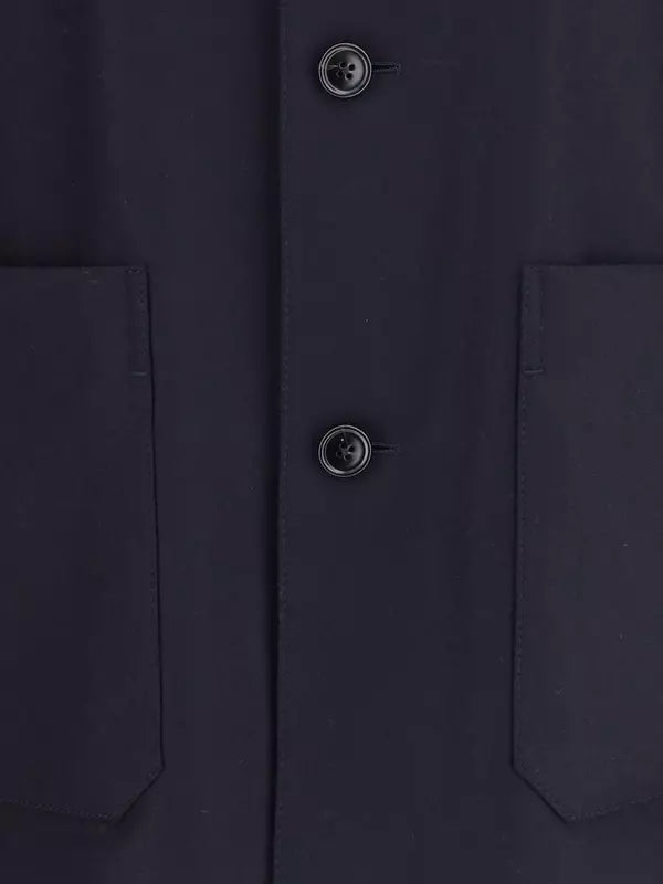 Close-up of a dark blue coat with button details
